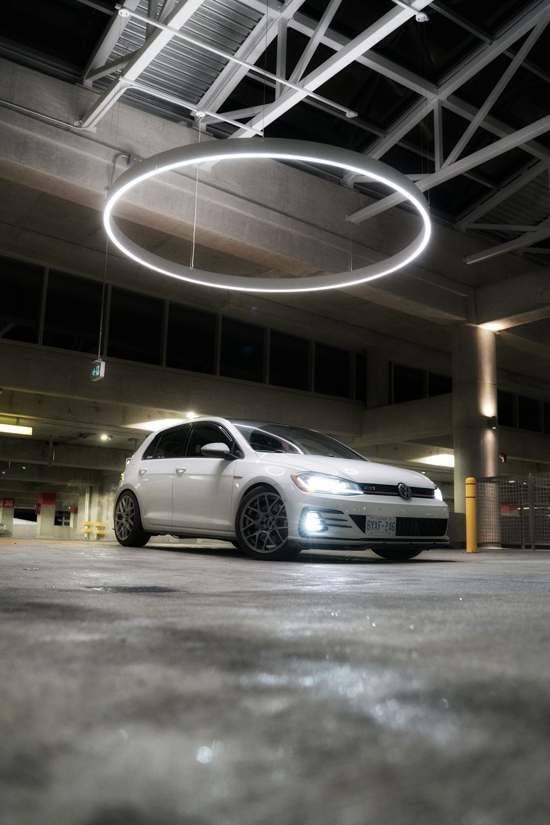 a-white-car-parked-in-a-parking-garage-lz4rg6c46lw